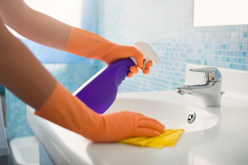 Vacuuming a mattress surface to remove dust and debris